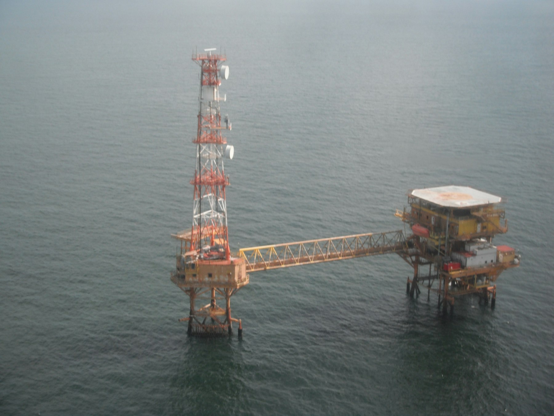 Aerial view of an offshore wellhead platform and bridge