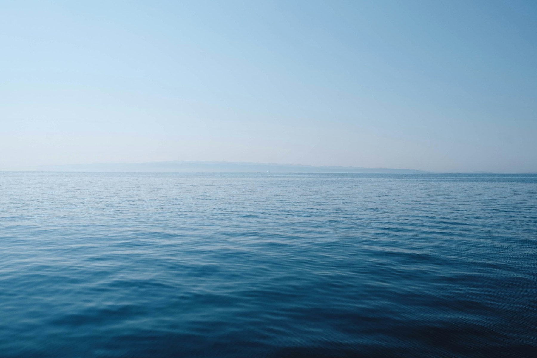 Calm open water under a clear sky